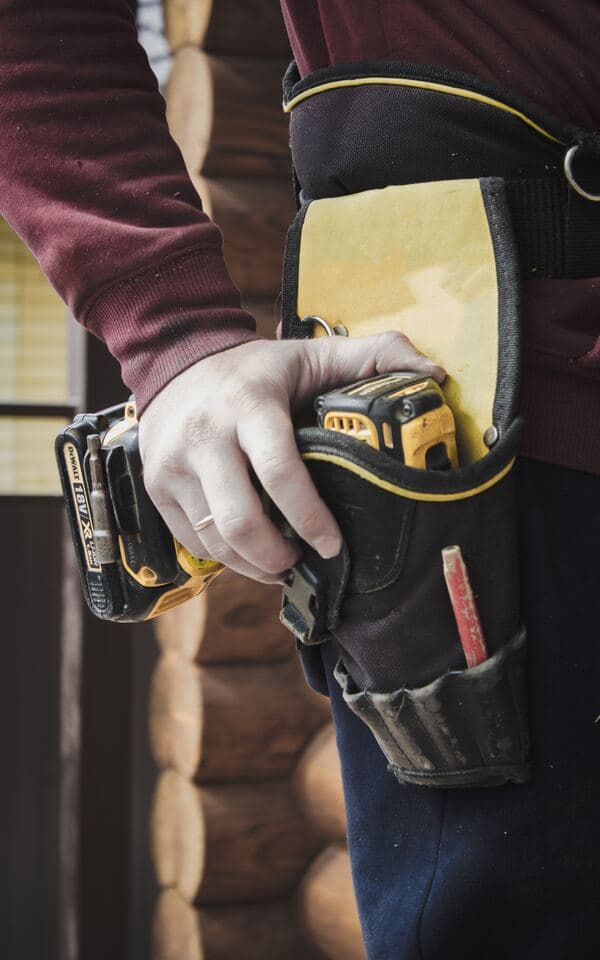 Electrician's hand holding a drill